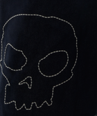 Dark denim fabric with white stitched skull outline, streetwear style detail