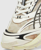 Close-up of cream and black lace-up sneaker with mesh and graphic details