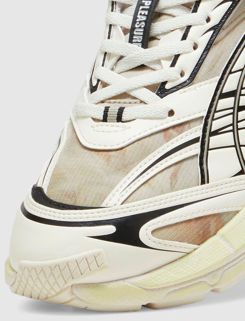 Close-up of cream and black lace-up sneaker with mesh and graphic details