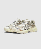 Cream and black Velophasis sneakers with graphic details and Pleasures logo on side