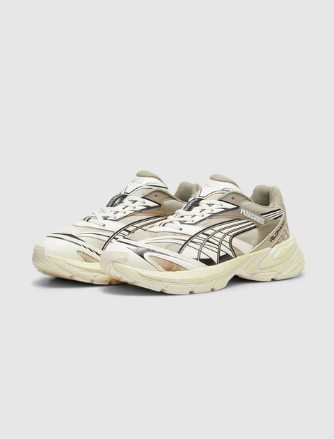 Cream and black Velophasis sneakers with graphic details and Pleasures logo on side