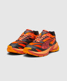 Red and orange mesh sneakers with black accents, chunky sole, and bold side logo