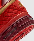 Close-up of red and gold men's streetwear sneaker with textured suede and rubber sole