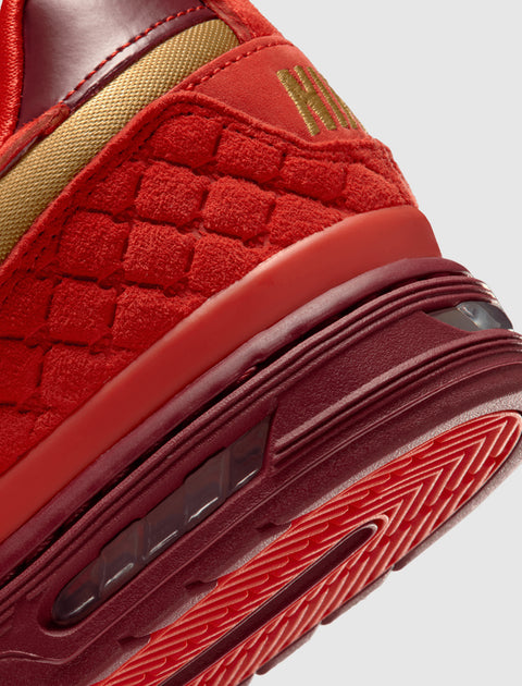 Close-up of red and gold men's streetwear sneaker with textured suede and rubber sole