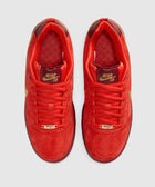 Red Nike SB sneakers with gold accents and patterned insoles, top view