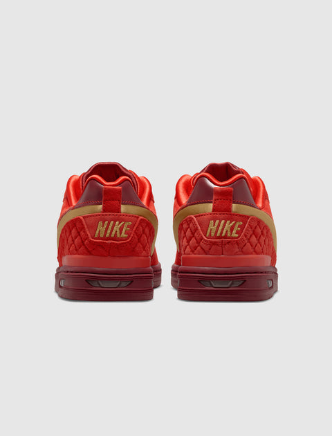 Back view of red and gold low-top Nike sneakers with quilted texture on heels