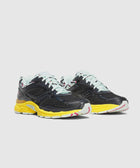 Black mesh athletic sneakers with yellow soles, light mint laces, and colorful accents