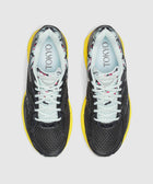 Top view of black mesh sneakers with yellow soles, white laces, floral lining, and TOKYO text