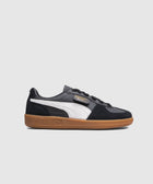Black and white low-top sneaker with gum sole, side logo detail, classic streetwear style
