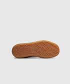 Gum sole of a sneaker with circular tread pattern on a white background