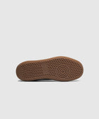 Gum rubber sneaker outsole with circular grip pattern and embossed logo on white background