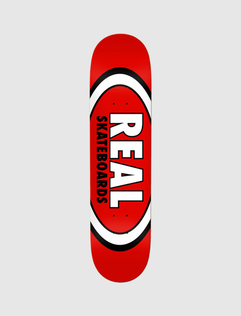 Red skateboard deck with bold white and black oval logo and lettering reading 'REAL SKATEBOARDS'.
