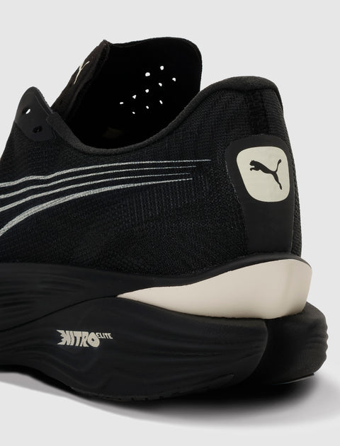 Close-up of black running sneaker heel with white Puma logo and Nitro Elite sole.