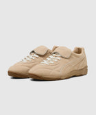 Beige suede indoor sneakers with gum sole and lace-up closure on white background