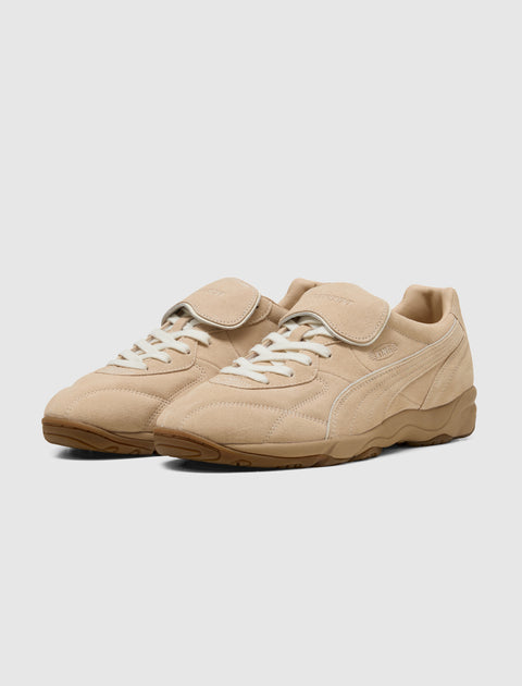 Beige suede indoor sneakers with gum sole and lace-up closure on white background