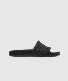 Black sculpted slide sandal with textured upper and contoured sole on white background