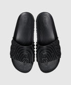 Black sculpted slides with textured strap and contoured footbed on a light background