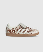White and brown cow print sneaker with gum sole and classic three stripe design