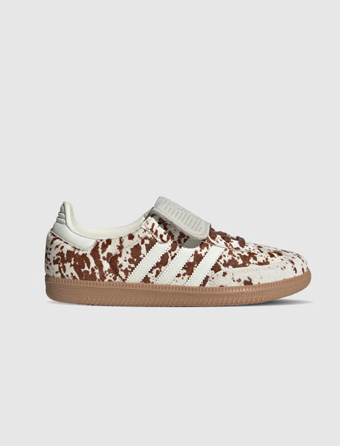 White and brown cow print sneaker with gum sole and classic three stripe design