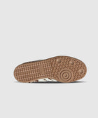 Brown rubber sneaker sole with circular traction pattern on a white background