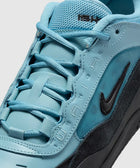Close-up of a turquoise and black sneaker with mesh and suede textures, Nike Swoosh logo visible.