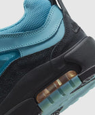 Close-up of blue and black sneaker with mesh upper, suede accents, and visible air sole unit
