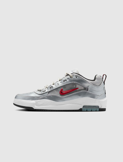 Metallic silver and white low-top sneaker with red side swoosh logo and visible air sole unit