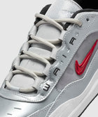 Metallic silver and red Nike sneaker with embroidered Swoosh and AIR text detailing