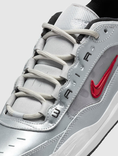 Metallic silver and red Nike sneaker with embroidered Swoosh and AIR text detailing