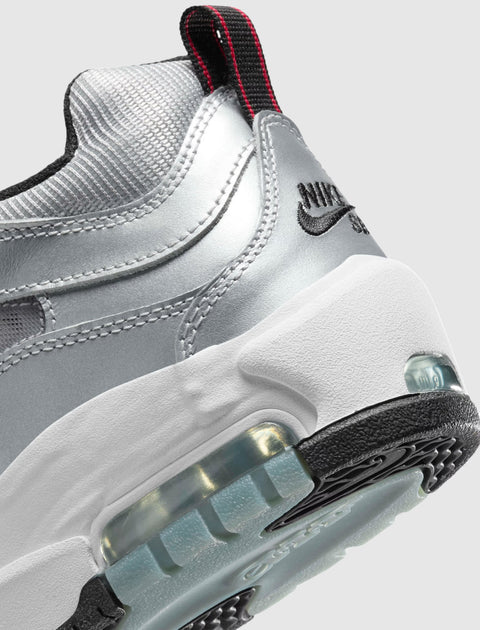 Close-up of metallic silver sneaker heel with visible air cushion and black outsole