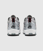 Silver and white Nike SB Air Max sneakers with red accents, rear view on light background