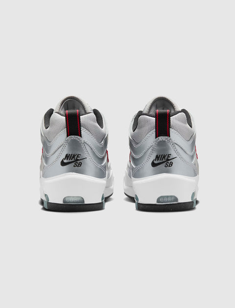 Silver and white Nike SB Air Max sneakers with red accents, rear view on light background