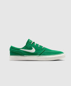 Green low-top suede sneaker with white sole and white side swoosh logo on gray background