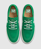 Green suede skate sneakers with white laces, white stitching, cork insoles, top view