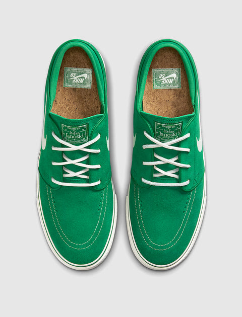 Green suede skate sneakers with white laces, white stitching, cork insoles, top view