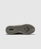 Close-up of a sneaker outsole with textured grey grip and star logo, streetwear footwear