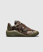 Men's low-top sneaker with green and brown camouflage pattern on a light background