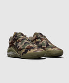 Men's sneakers with green camo print, side zip detail, and chunky sole on gray background