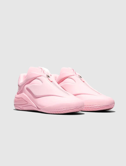Pair of light pink slip-on sneakers with a sleek, modern design on a plain background