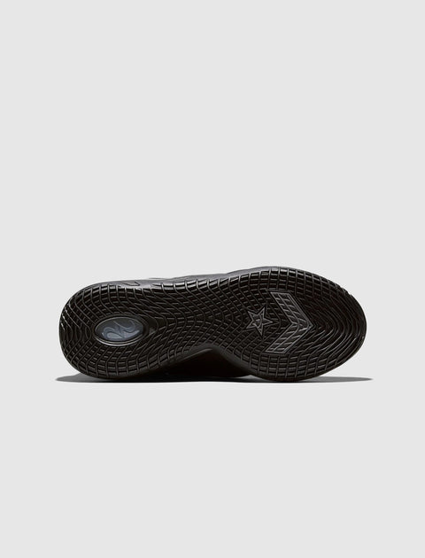 Black sneaker outsole with textured grip pattern and star chevron logo on light background