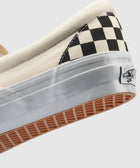 Close-up of slip-on sneaker with black and white checkerboard pattern and waffle sole