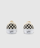 Black and white checkerboard slip-on sneakers rear view on white background