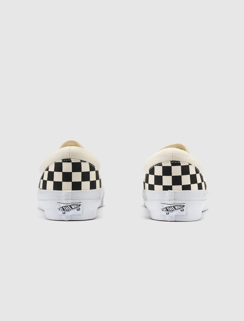 Black and white checkerboard slip-on sneakers rear view on white background