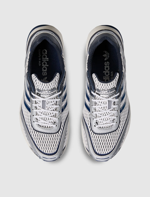 Pair of white and navy mesh athletic sneakers with blue stripes, top view