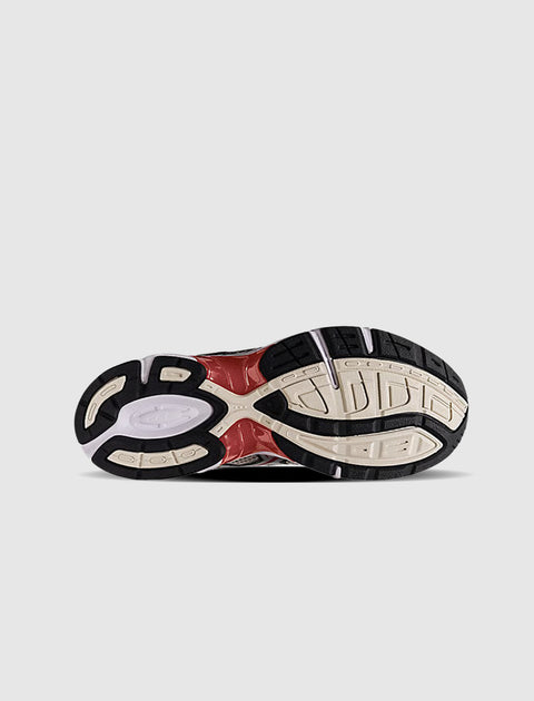 Streetwear sneaker outsole with black, beige, and red tread pattern on white background