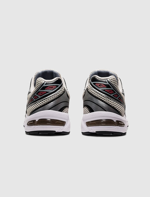 Rear view of smoke grey and silver mesh athletic sneakers with black and red accents