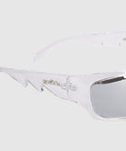 Clear frame sunglasses with silver-tinted lenses and unique angular arms on a light background