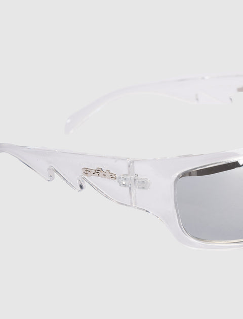 Clear frame sunglasses with silver-tinted lenses and unique angular arms on a light background