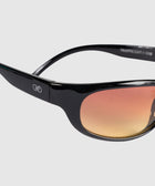 Black sunglasses with orange gradient lenses and a small white logo on the temple