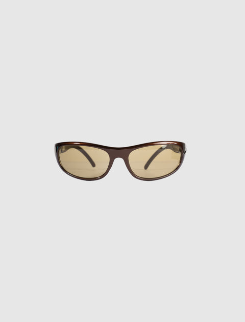Brown wraparound sunglasses with yellow tinted lenses on a white background